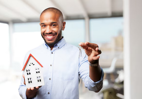 Person holding a small model house